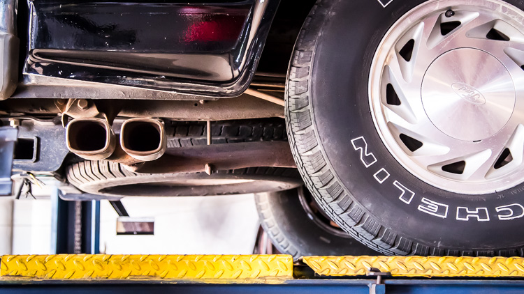Vehicle on shop lift for failed emissions in Douglasville
